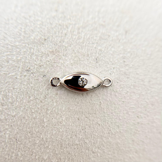 Sterling silver evil eye charm with cubic zirconia, a symbol of protection.