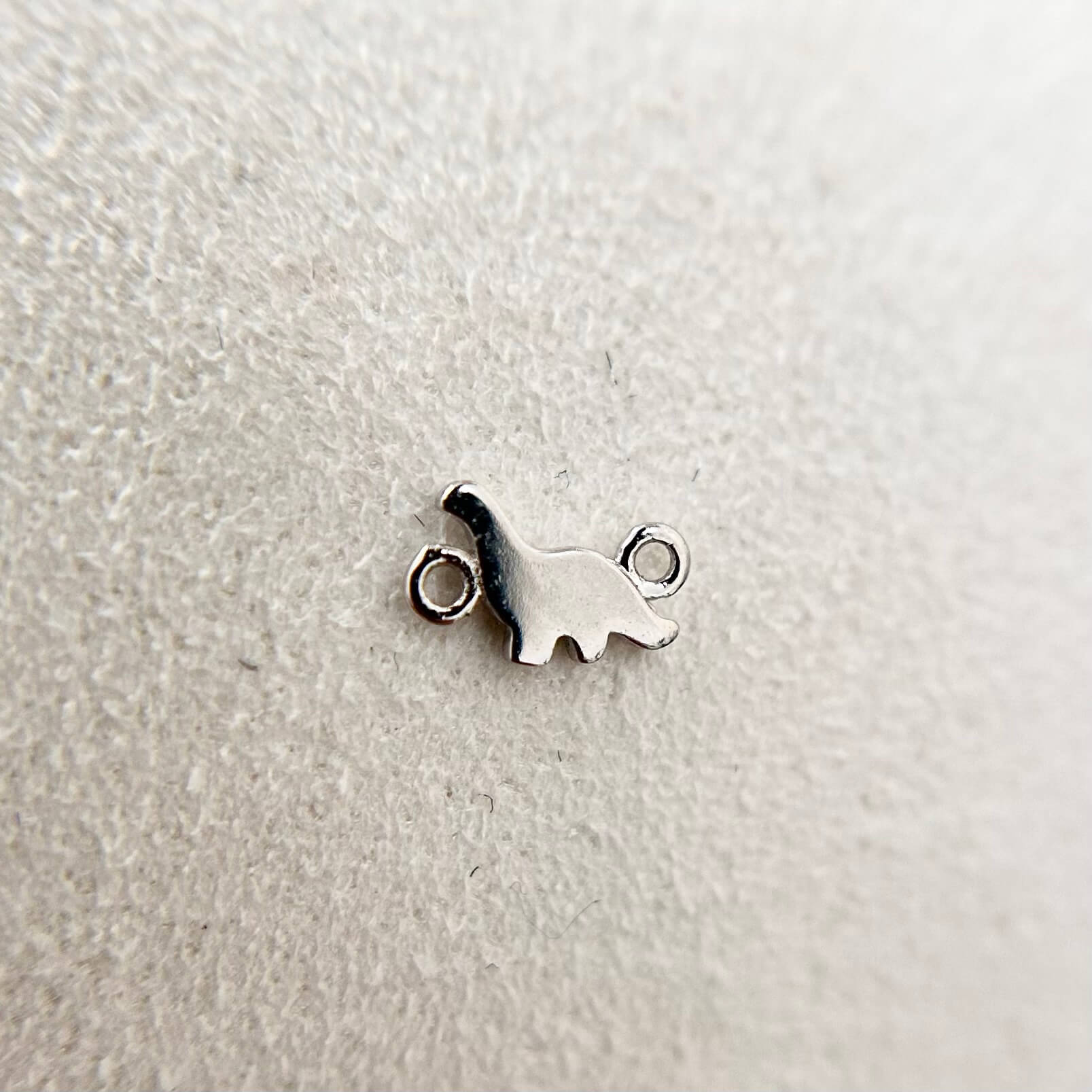 9ct solid white gold dinosaur charm, playful detail in luxury finish.