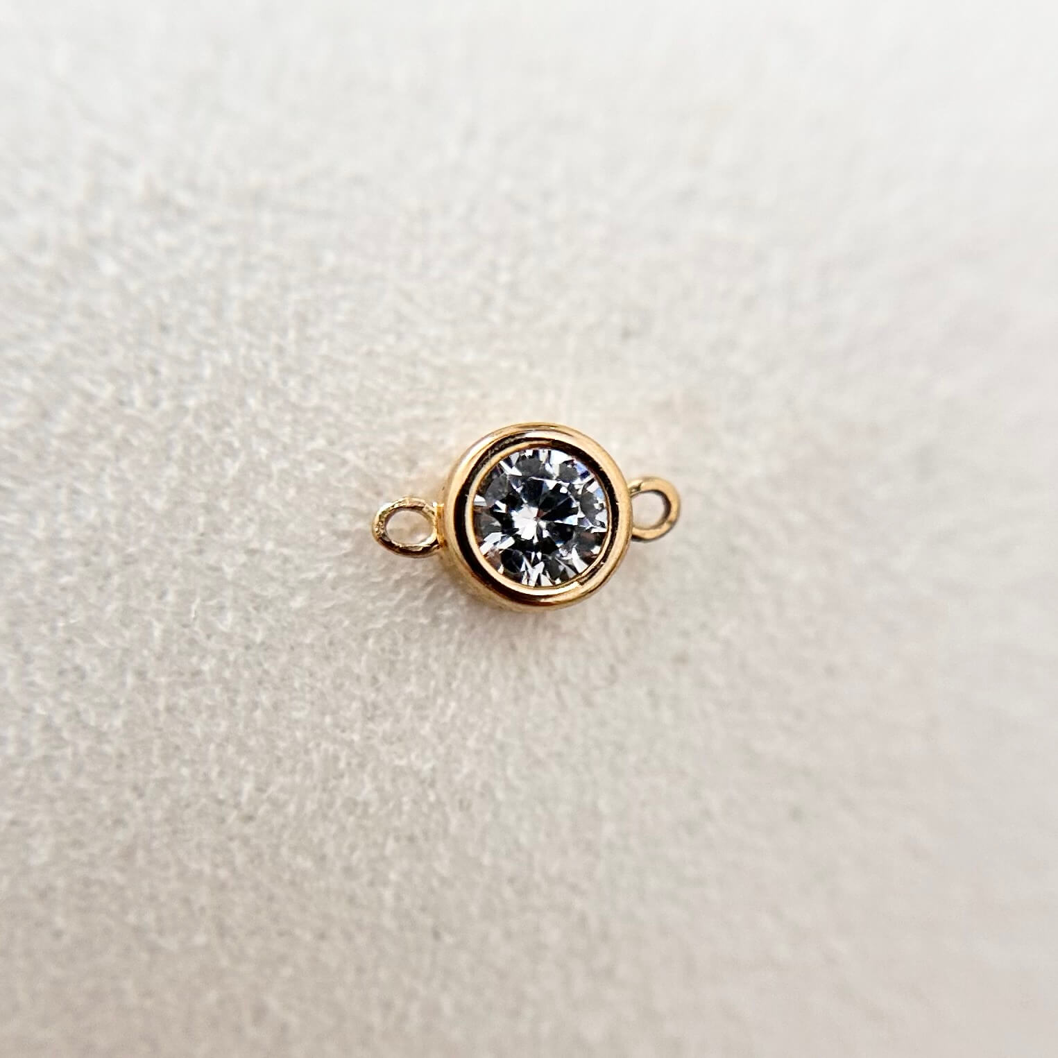 Gold vermeil bezel-set cubic zirconia charm, timeless and elegant.